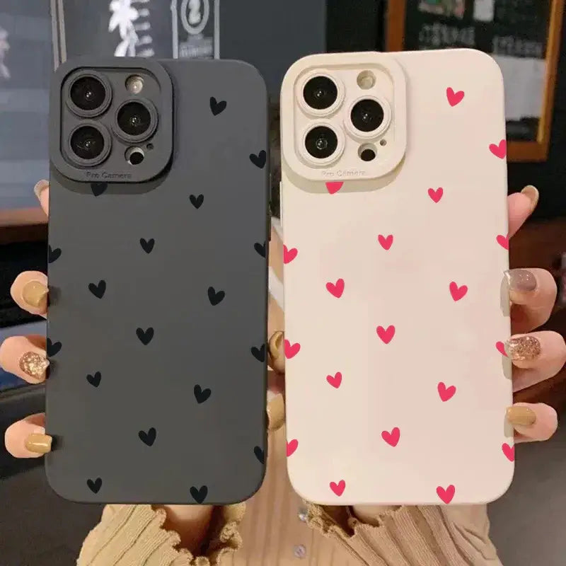 Black and white heart-patterned iPhone cases showcasing stylish, protective designs for various iPhone models.